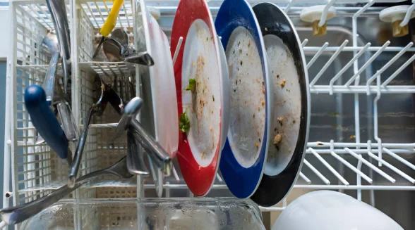 Dirty-dishes-on-a-dishwasher-for-cleaning