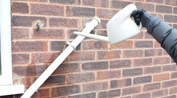 homeowner-is-thawing-a-frozen-condensate-pipe