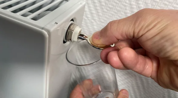 heating-engineer-is-bleeding-the-radiator