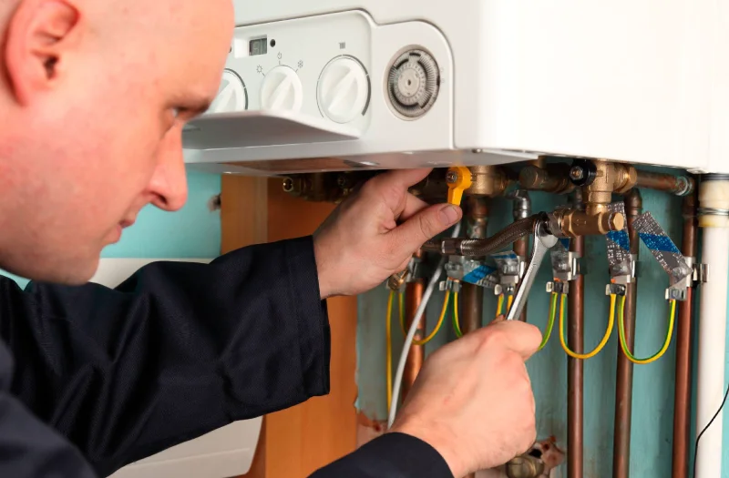 heating-engineer-is-checking-Pressure-Relief-Valve-on-a-boiler