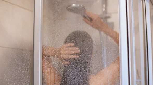 woman-is-enjoying-her-electric-shower-bath
