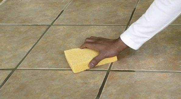 person-is-wiping-the-bathroom-tile-floor