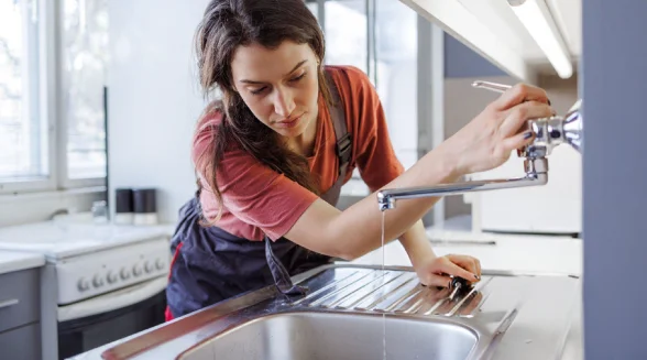 female-plumber-investigating-noise-coming-from-Insinkerator