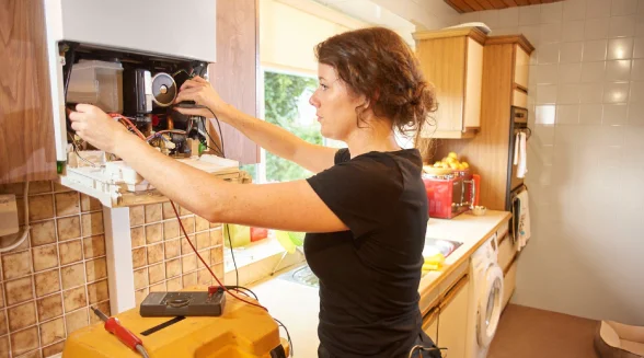 female-plumber-repairing-a-boiler