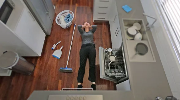 woman-lying-next-to-a-broken-dishwasher