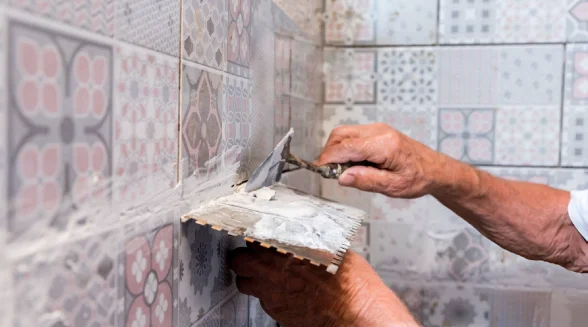 tradesperson-is-adding-grout-to-old-tiles