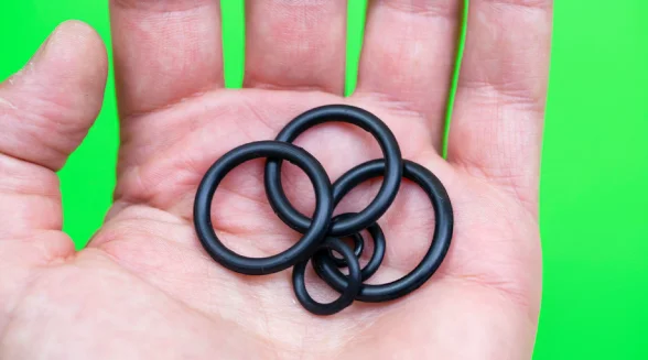 person-is-holding-a-few-washers-in-his-hand
