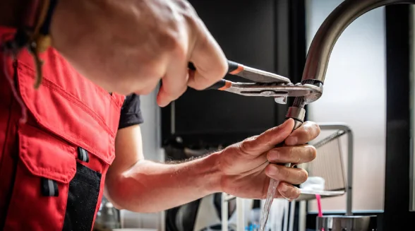 tradesperson-is-repairing-a-dripping-tap