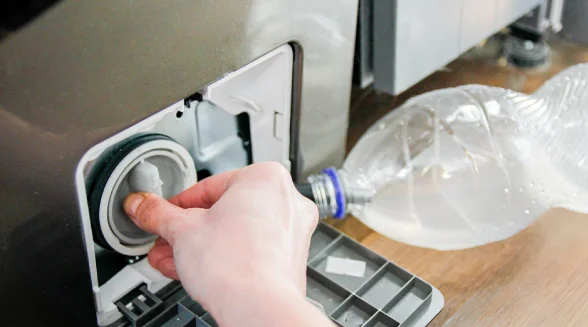 person-is-unplugging-a-washing-machine-filter