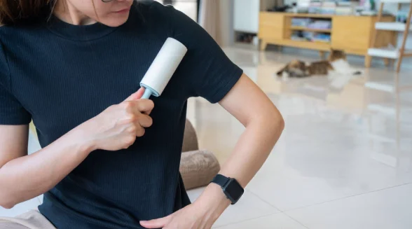 woman-is-removing-lint-from-clothes