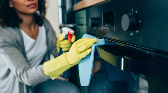 woman-is-wiping-the-oven-door