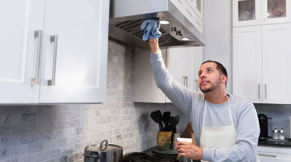 man-is-cleaning-a-range-hood