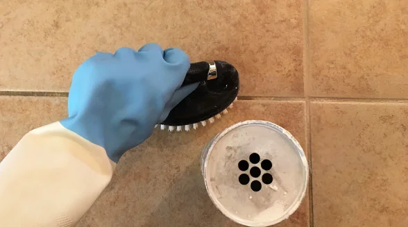 person-cleaning-the-tile-grout