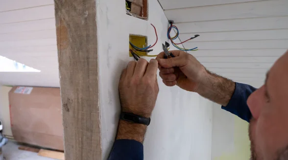 electrician-is-rewiring-a-wall-socket