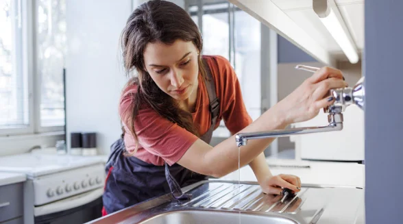 female-plumber-is-checking-a-tap