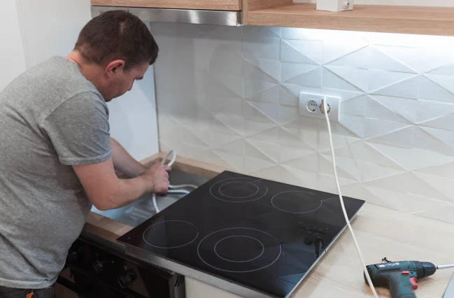 man-is-doing-cooker-installation