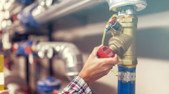 technician-is-adjusting-a-valve-in-a-factory