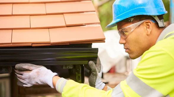 tradesperson-sealing-a-gutter-leak-in-london