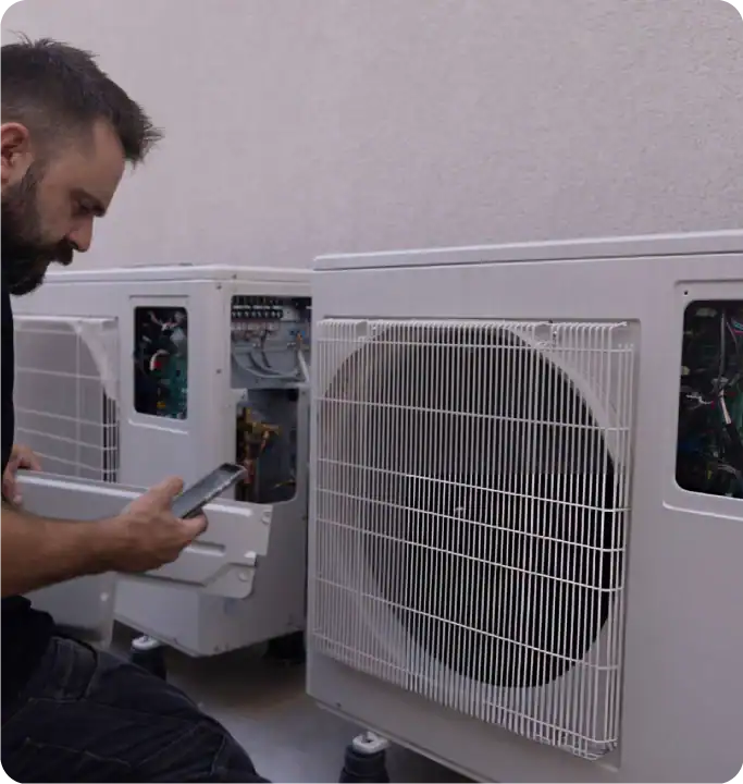 F-Gas certified heat pump engineer is servicing Mitsubishi Ecodan outdoor unit F-Gas certified heat pump engineer is servicing Mitsubishi Ecodan outdoor unit