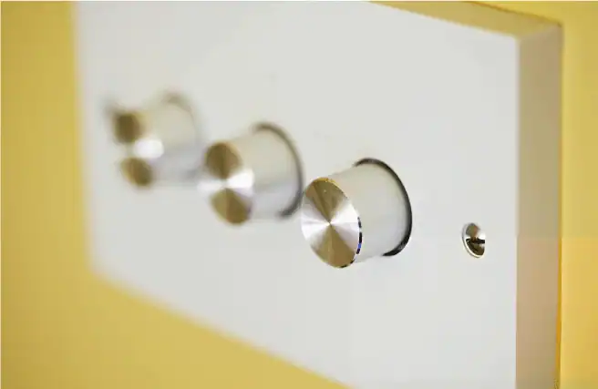 Three dimmer light switches are on a raw