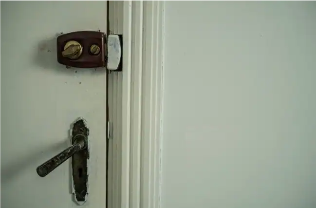 ALT -  misaligned door lock on a white door