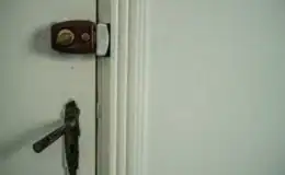 A-misaligned-door-lock-on-a-white-door