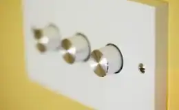 Three-dimmer-light-switches-are-on-a-raw